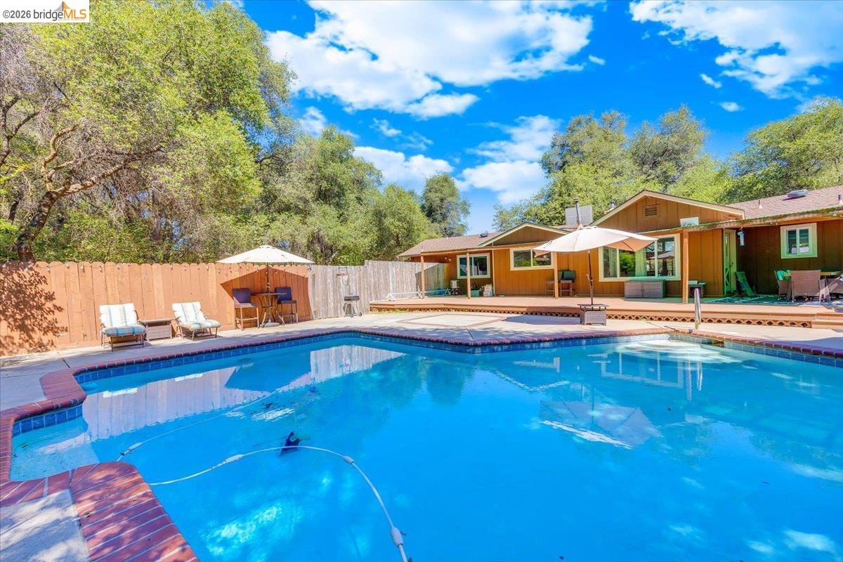 8733 Fraguero Road Sonora, CA 95370 - Photo 58 of 73 In-ground swimming pool with integrated spa and surrounding concrete decking