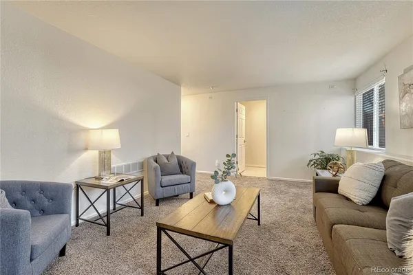 a living room with furniture and a lamp