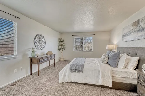 a bedroom with a large bed and a chandelier