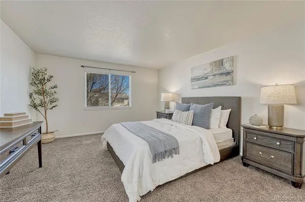a bedroom with a bed and a night stand
