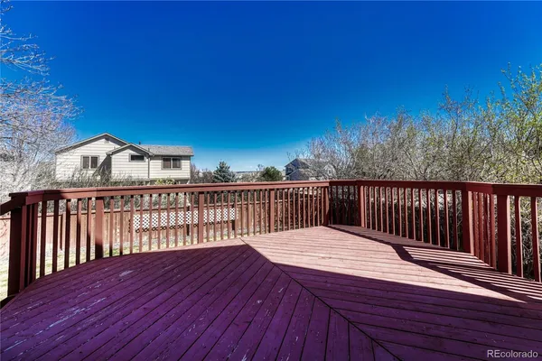 a balcony with wooden floor and city view