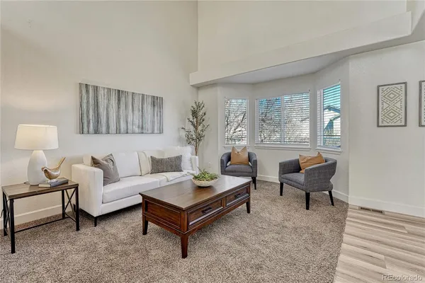 a living room with furniture and a potted plant on table