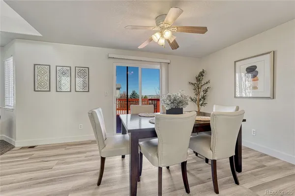 a view of a dining room with furniture and wooden floor