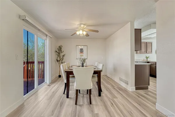 a view of a dining room with furniture and wooden floor