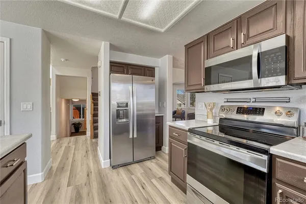 a kitchen with a stove microwave and refrigerator