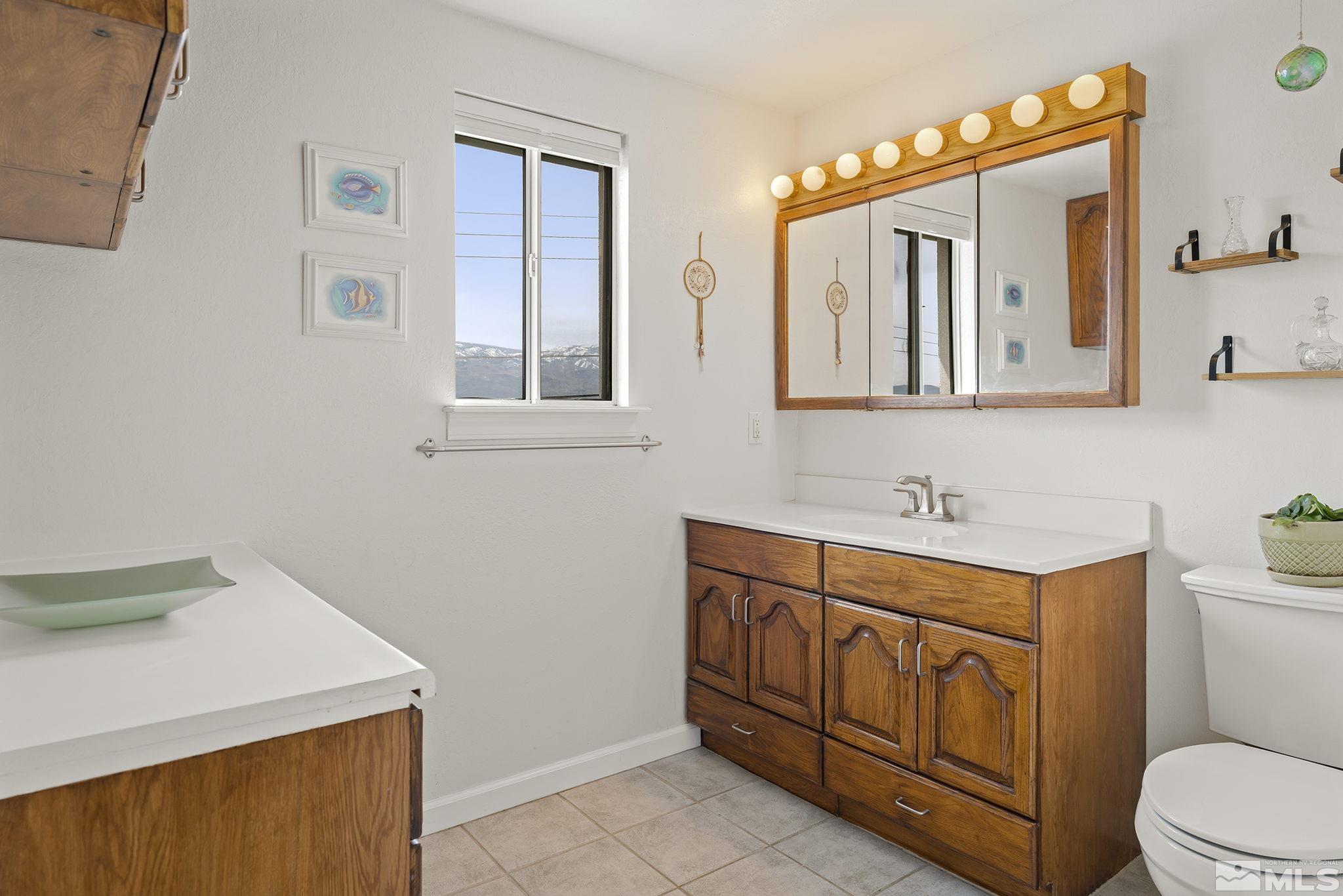 2660 Polk Street Reno, NV 89503 - Photo 18 of 40 a bathroom with a sink a toilet and mirror