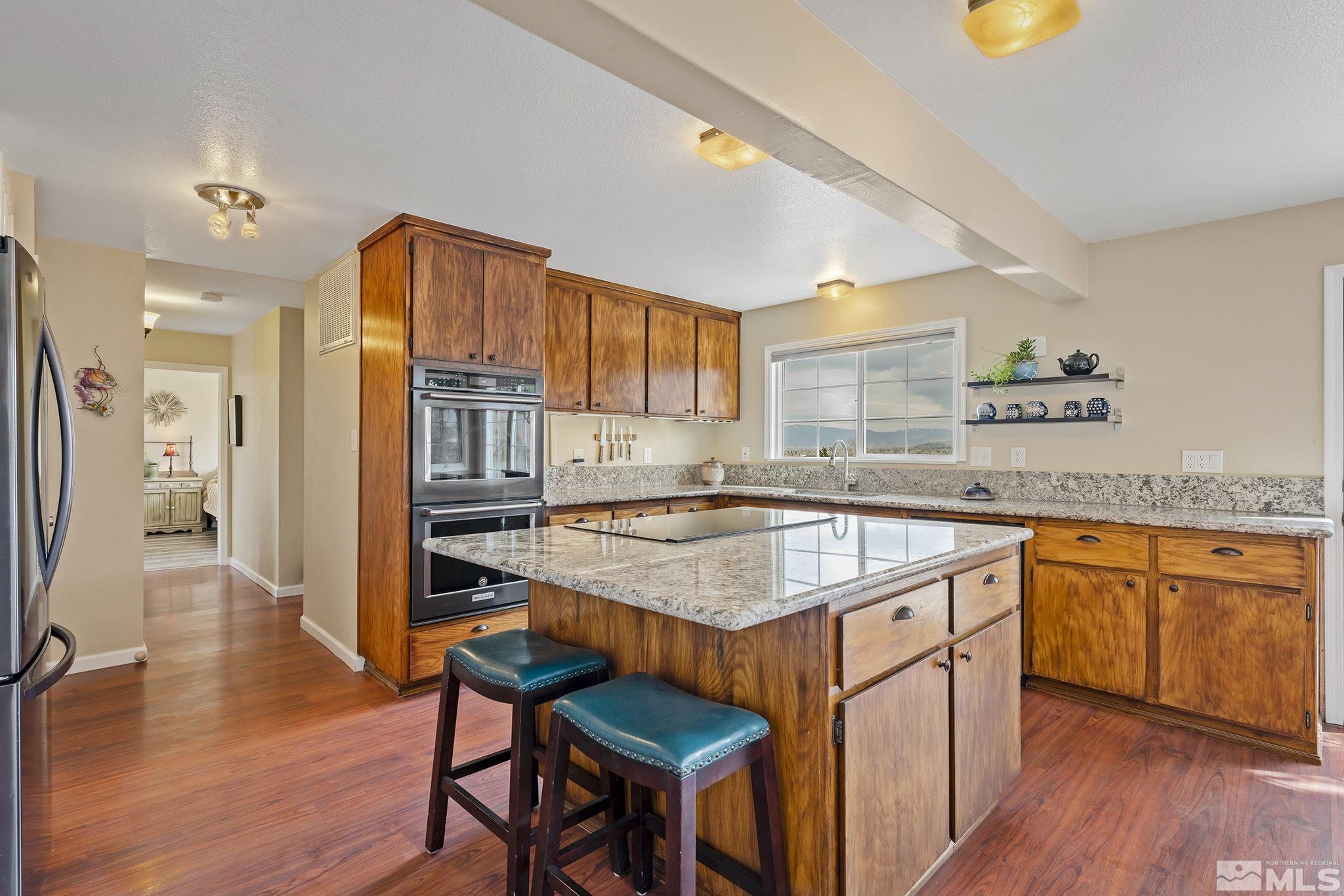 2660 Polk Street Reno, NV 89503 - Photo 10 of 40 a kitchen with stainless steel appliances granite countertop a stove a sink and a refrigerator