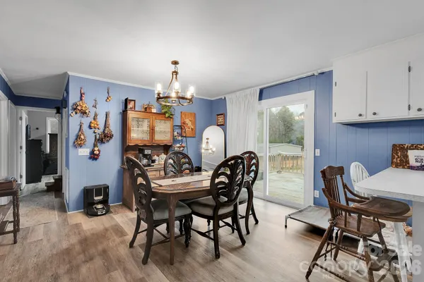 a view of a dining room with furniture wooden floor and chandelier