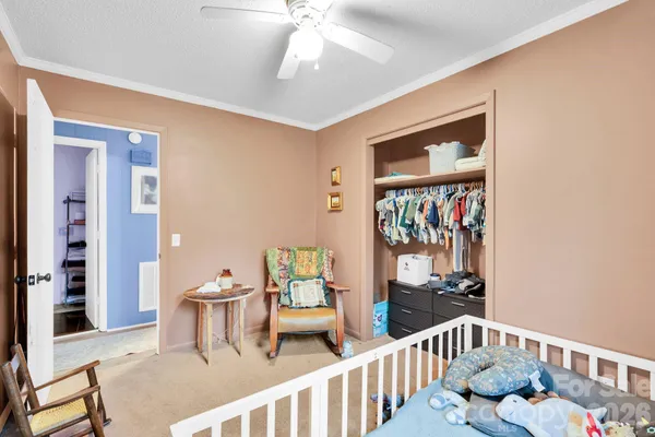 a bedroom with a bed and a television
