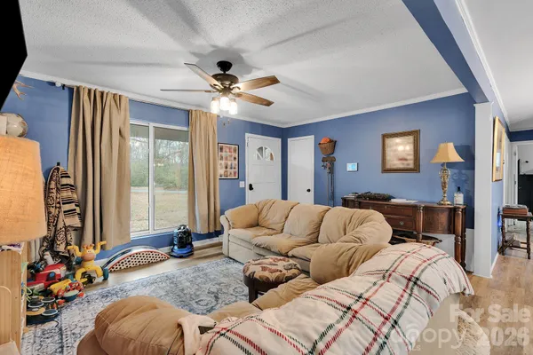 a bedroom with a bed couch and window