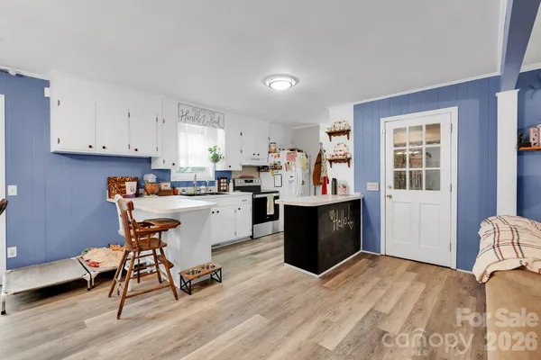 a kitchen with a refrigerator and wooden cabinets
