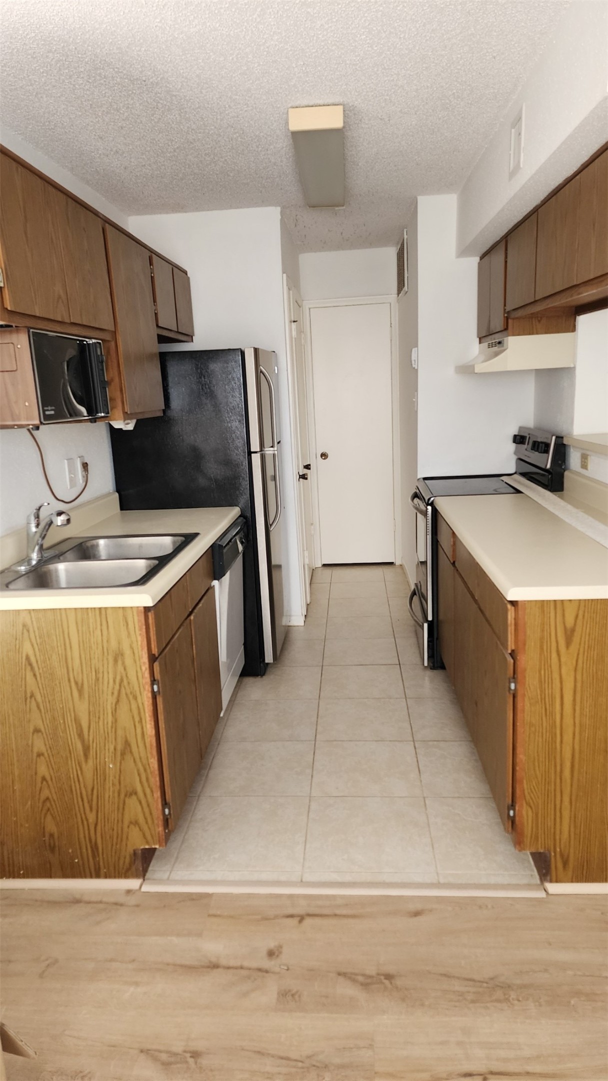 2750 Holly Hall Street, Unit 101 Houston, TX 77054 - Photo 1 of 6 a kitchen with stainless steel appliances granite countertop a sink stove and refrigerator
