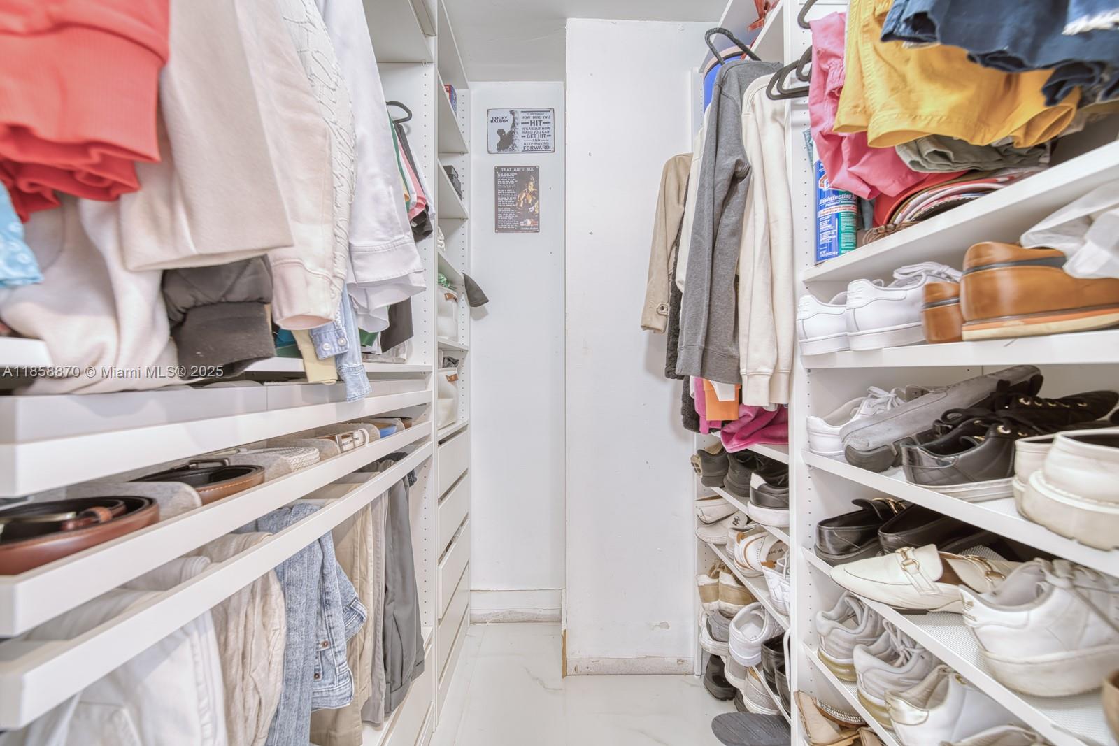 7601 East Treasure Drive, Unit 2424 North Bay Village, FL 33141 - Photo 11 of 25 a view of walk in closet with clothes and shoes