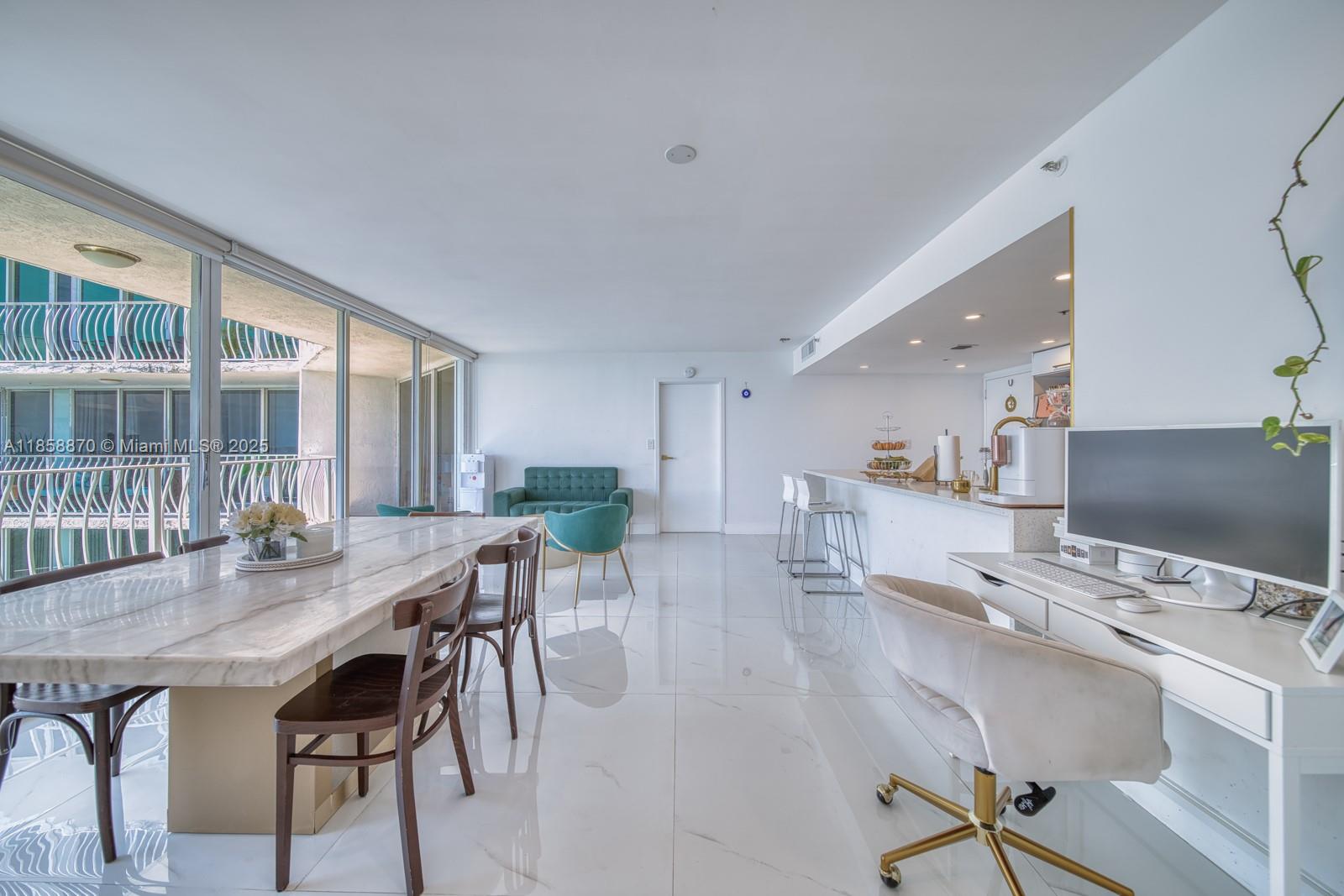 7601 East Treasure Drive, Unit 2424 North Bay Village, FL 33141 - Photo 2 of 25 a view of a dining room with furniture and a table