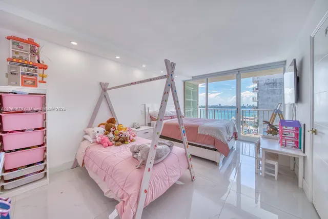 a bedroom with furniture and a large window