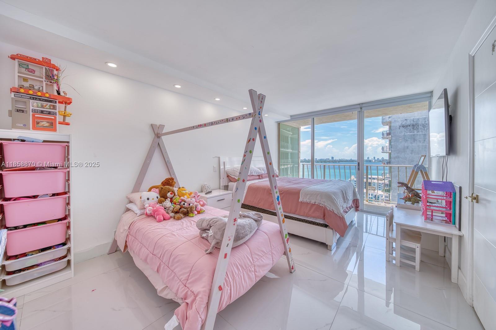 7601 East Treasure Drive, Unit 2424 North Bay Village, FL 33141 - Photo 22 of 25 a bedroom with furniture and a large window