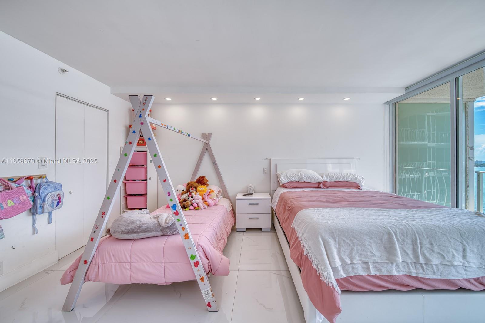 7601 East Treasure Drive, Unit 2424 North Bay Village, FL 33141 - Photo 24 of 25 a bedroom with a bed and a window