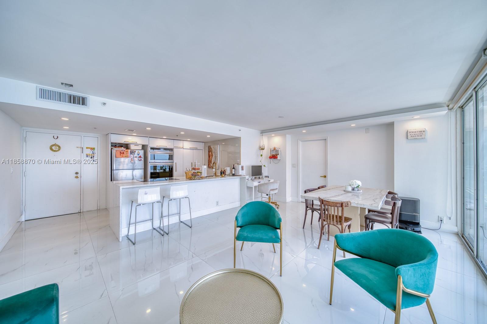 7601 East Treasure Drive, Unit 2424 North Bay Village, FL 33141 - Photo 4 of 25 a living room with furniture and a table