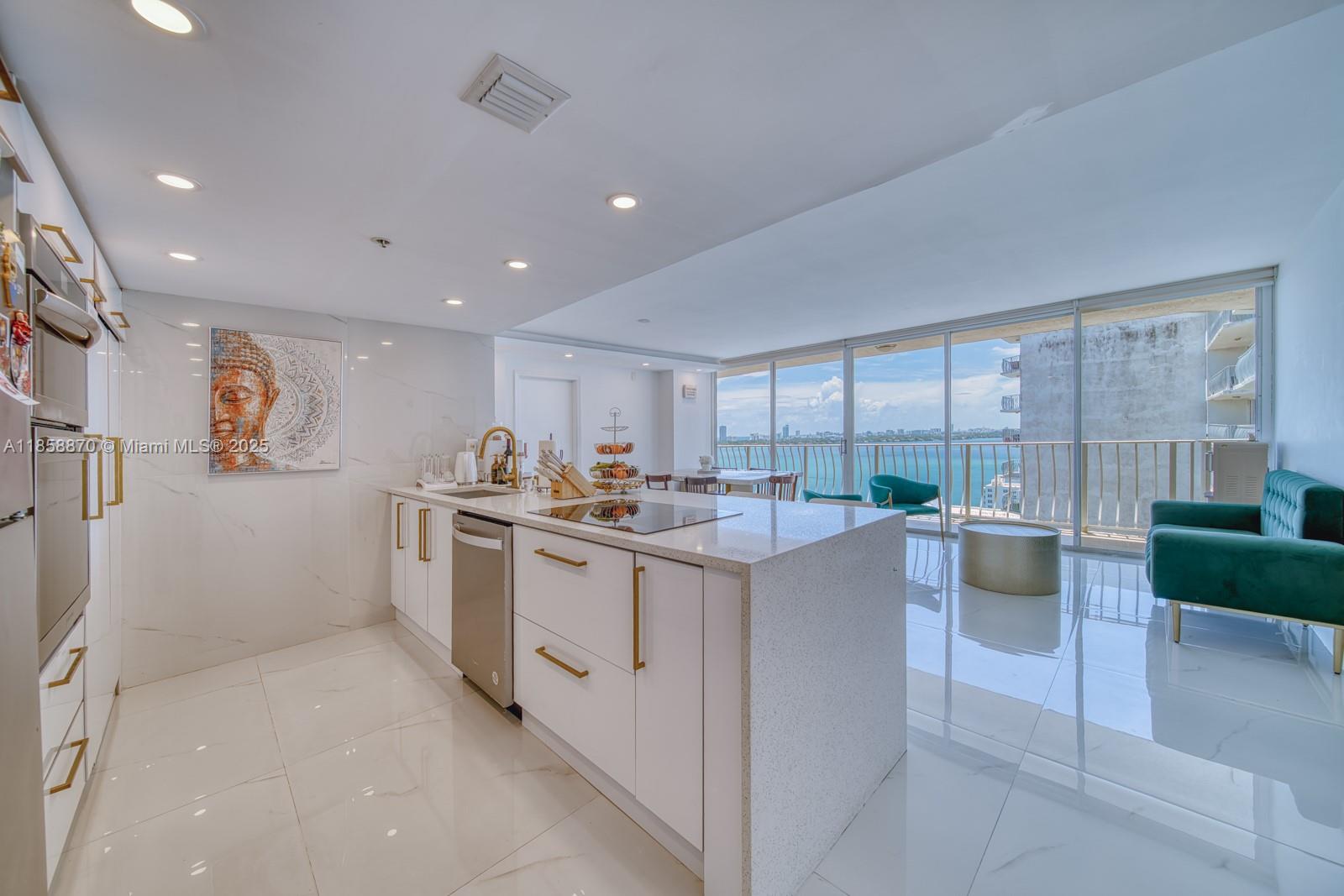 7601 East Treasure Drive, Unit 2424 North Bay Village, FL 33141 - Photo 5 of 25 a kitchen with a sink and counter top space
