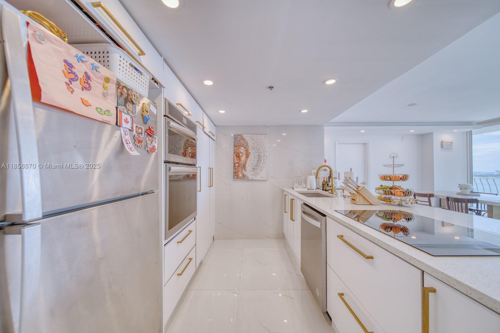 7601 East Treasure Drive, Unit 2424 North Bay Village, FL 33141 - Photo 6 of 25 a kitchen with stainless steel appliances granite countertop a refrigerator and a sink