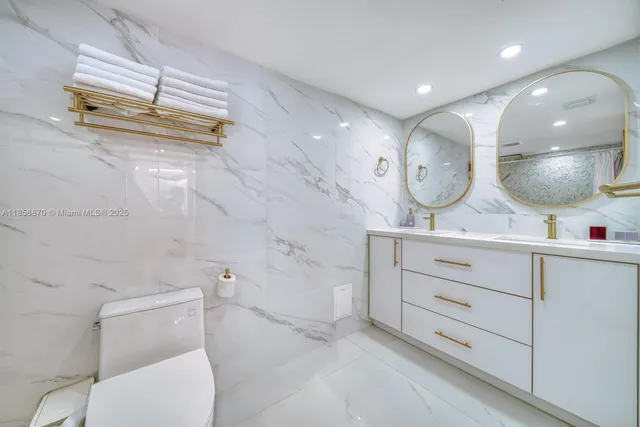 a bathroom with a toilet a sink and a mirror