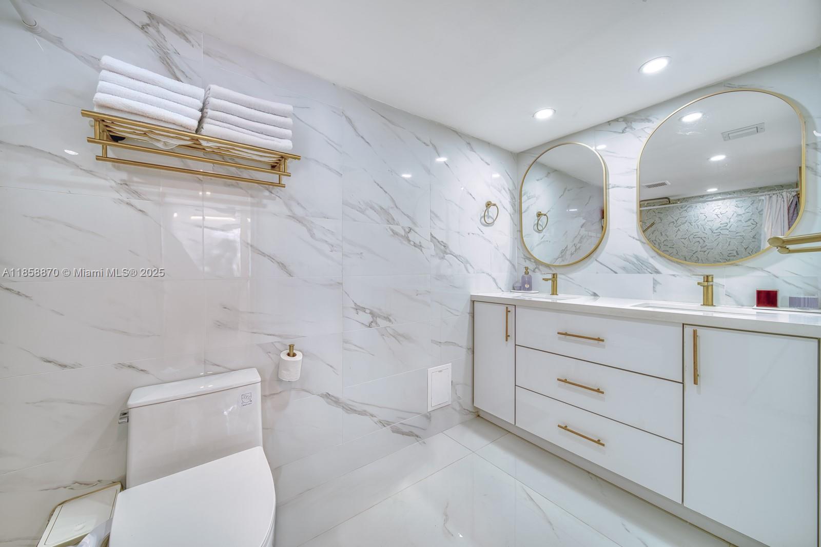 7601 East Treasure Drive, Unit 2424 North Bay Village, FL 33141 - Photo 10 of 25 a bathroom with a toilet a sink and a mirror