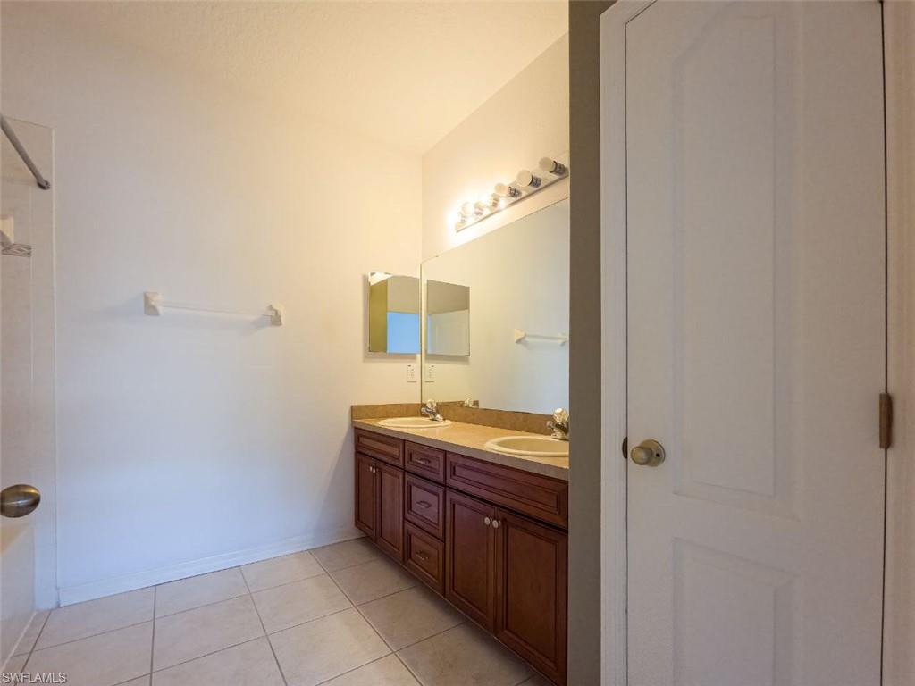 1044 Sleepy Oak Drive Zephyrhills, FL 33543 - Photo 14 of 19 a spacious bathroom with a granite countertop sink and a mirror