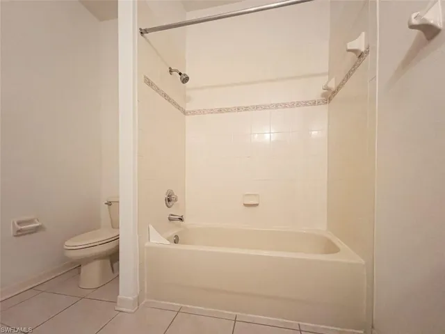 a bathroom with a bathtub a toilet and a shower