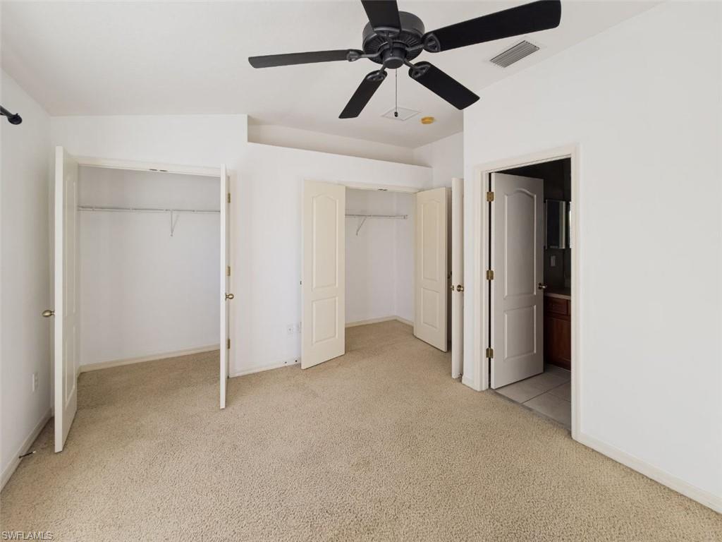 1044 Sleepy Oak Drive Zephyrhills, FL 33543 - Photo 18 of 19 an empty room with closet and a ceiling fan