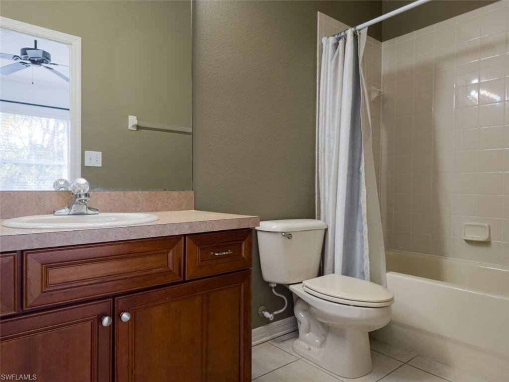 1044 Sleepy Oak Drive Zephyrhills, FL 33543 - Photo 19 of 19 a bathroom with a sink a toilet a mirror and shower
