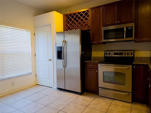 a kitchen with granite countertop cabinets and steel stainless steel appliances