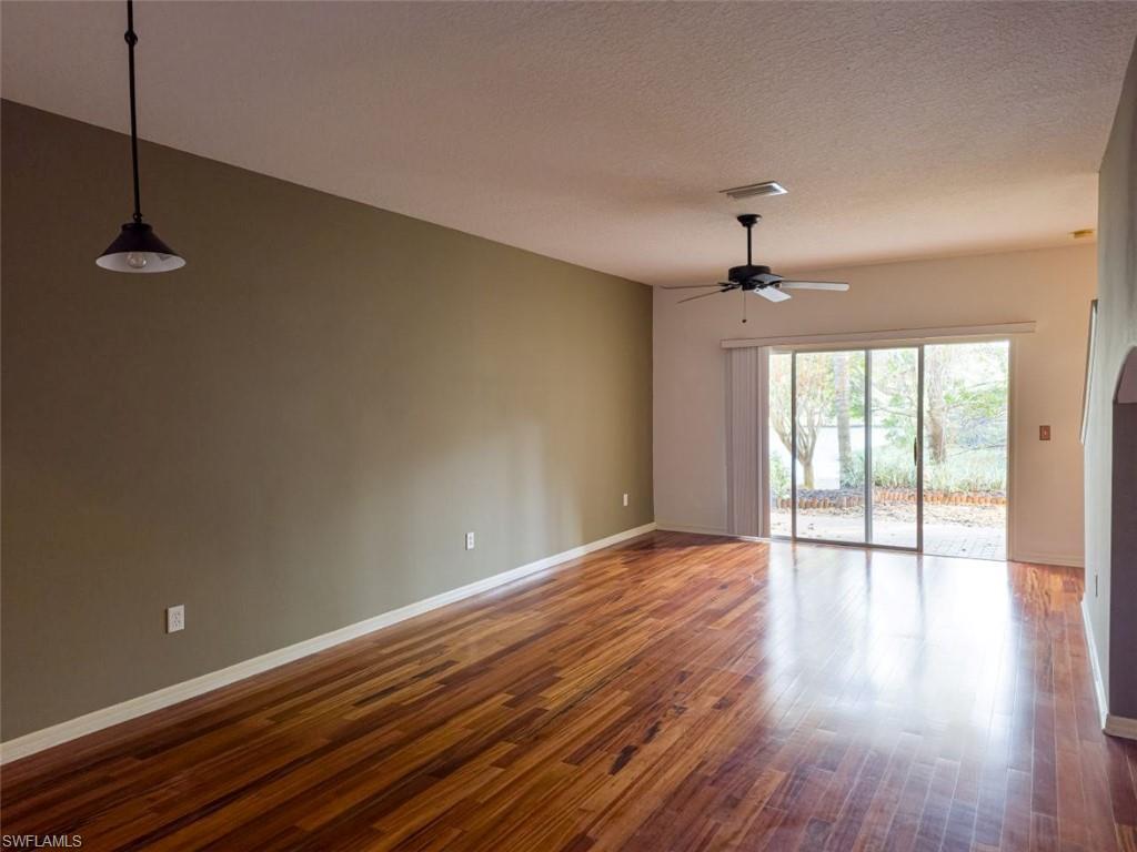 1044 Sleepy Oak Drive Zephyrhills, FL 33543 - Photo 7 of 19 a view of an empty room with wooden floor and a window