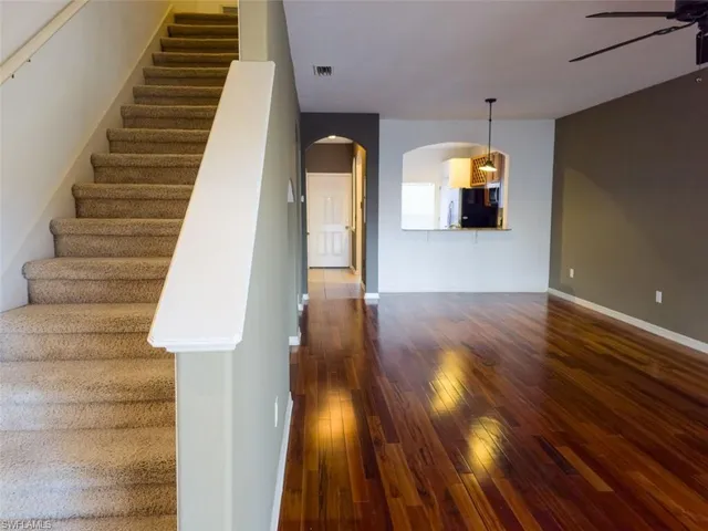 a view of entryway and hall with wooden floor