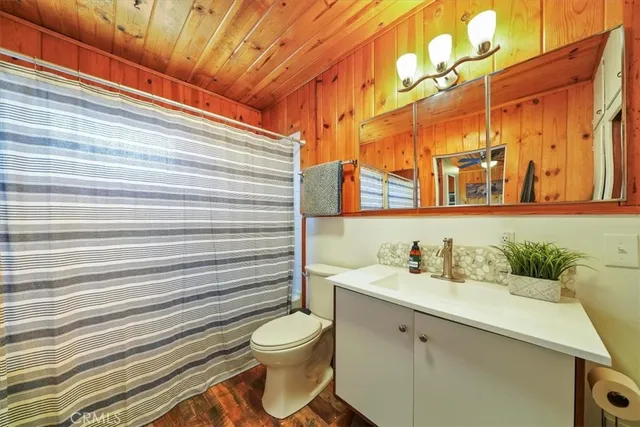 a bathroom with a sink mirror vanity and toilet