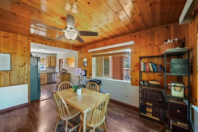 a dining room with furniture a chandelier and wooden floor