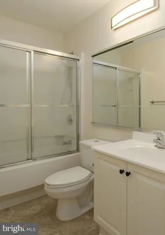 a bathroom with a shower a toilet and a sink