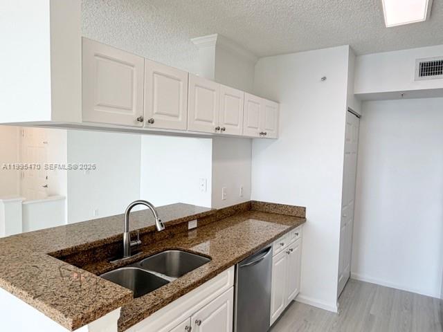 17100 North Bay Road, Unit 1604 Sunny Isles Beach, FL 33160 - Photo 14 of 37 a kitchen with a sink and cabinets