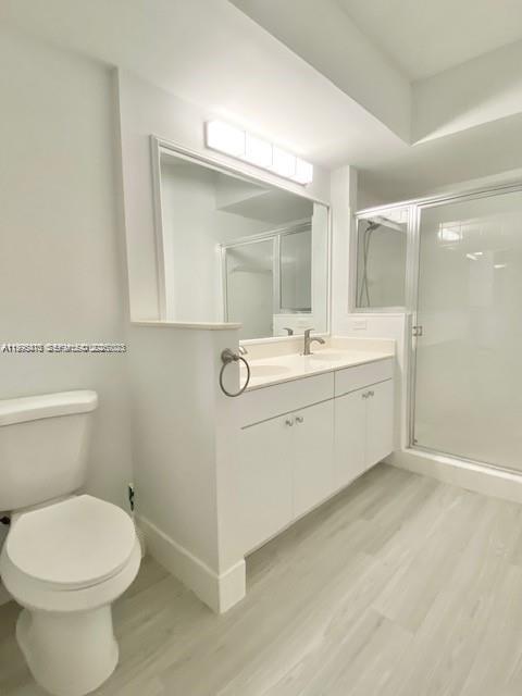 17100 North Bay Road, Unit 1604 Sunny Isles Beach, FL 33160 - Photo 20 of 37 a bathroom with a sink a toilet and mirror