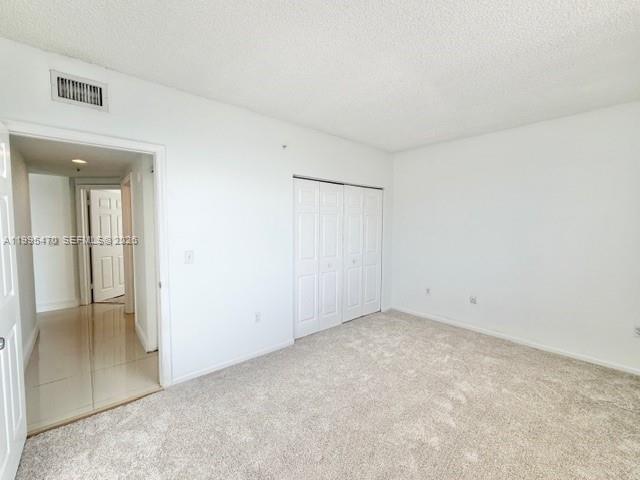 17100 North Bay Road, Unit 1604 Sunny Isles Beach, FL 33160 - Photo 28 of 37 an empty room with mirror and entrance