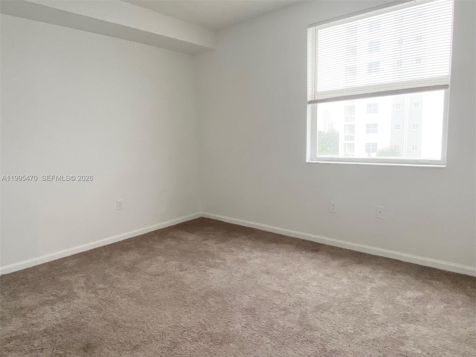 17100 North Bay Road, Unit 1604 Sunny Isles Beach, FL 33160 - Photo 29 of 37 an empty room with a window