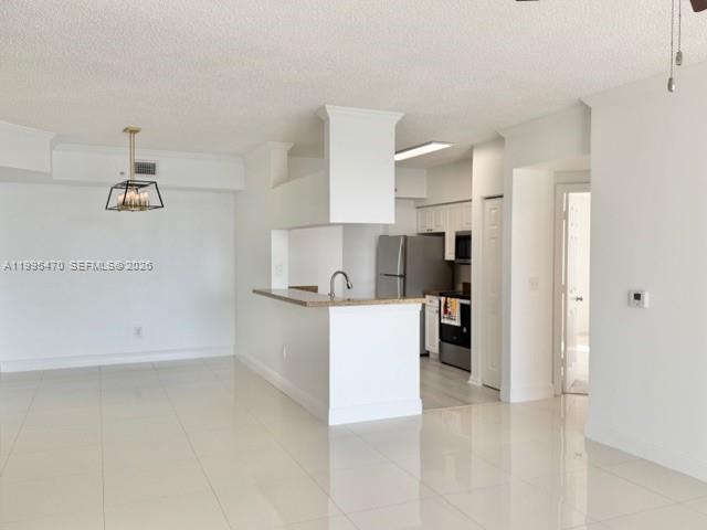 17100 North Bay Road, Unit 1604 Sunny Isles Beach, FL 33160 - Photo 6 of 37 a kitchen with cabinets and a refrigerator