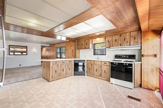 a kitchen with stainless steel appliances granite countertop a stove and a refrigerator