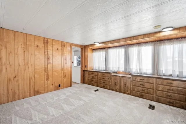 a large white room with wooden walls