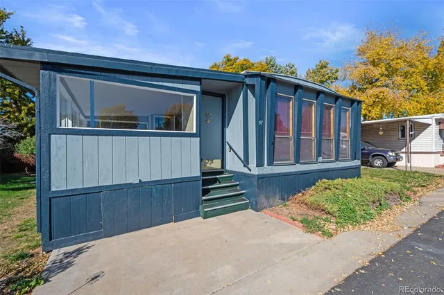 a view of a house with wooden fence