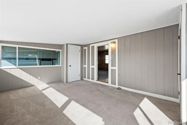 a view of an empty room with window and an empty room