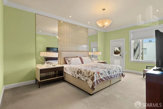 a spacious bedroom with a bed a table and potted plant on the table