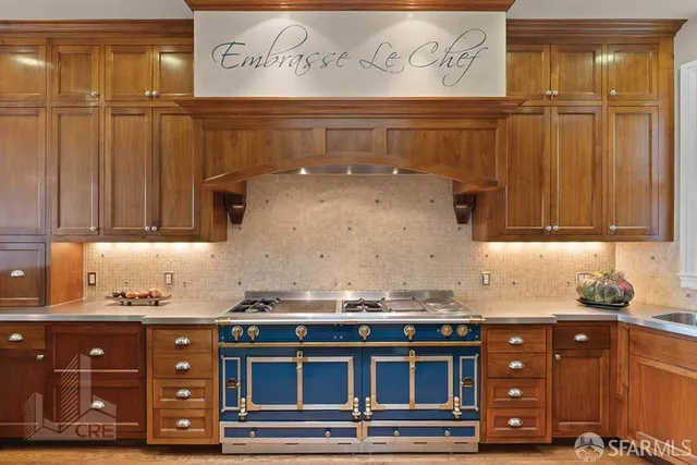 a kitchen with stainless steel appliances granite countertop a sink and cabinets