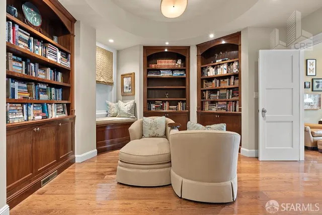 a living room with furniture and a book shelf