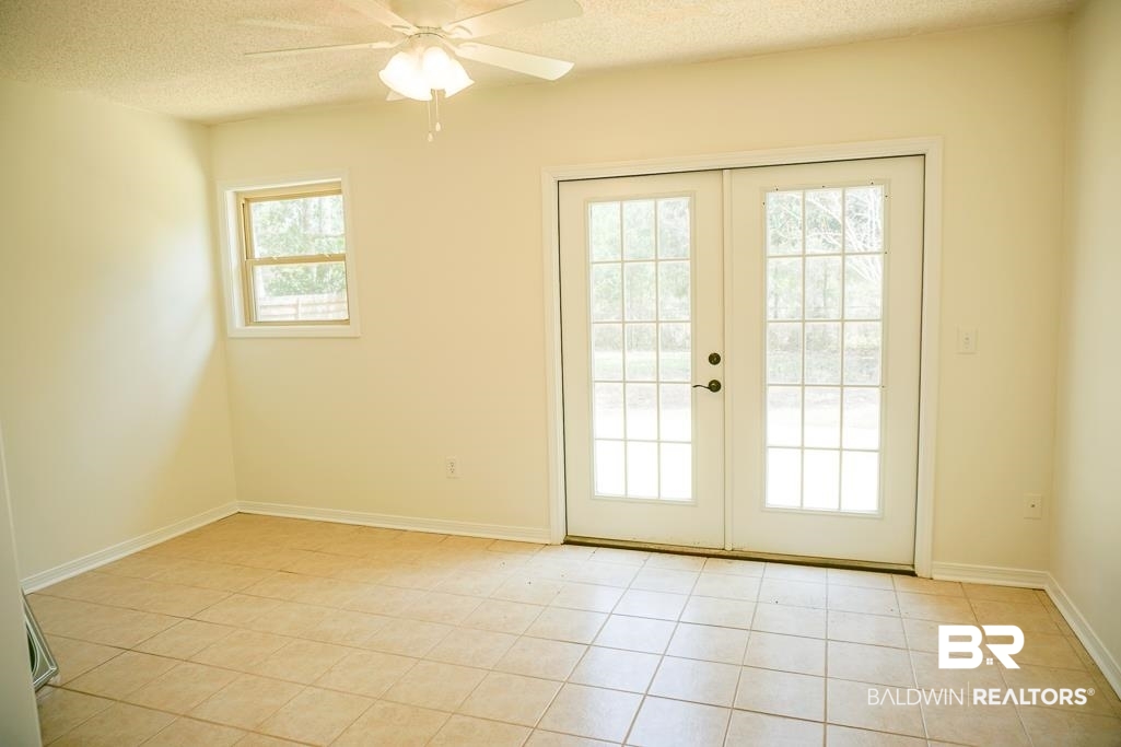 4377 Fathbrook Lane Mobile, AL 36693 - Photo 17 of 19 Doorway with baseboards, a textured ceiling, french doors, and ceiling fan
