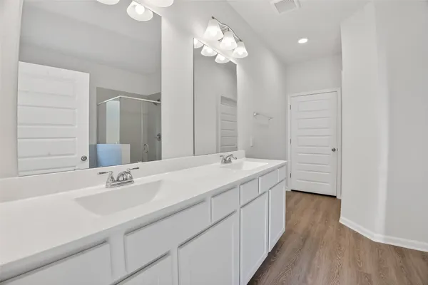 a bathroom with a double vanity sink and a mirror